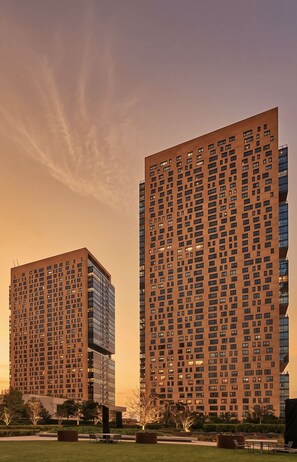 Zwei Hochhäuser vor einem klaren Himmel und einem Sonnenuntergang.