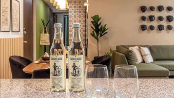 Two bottles of Casa del Agua natural wine on a counter with two glasses.