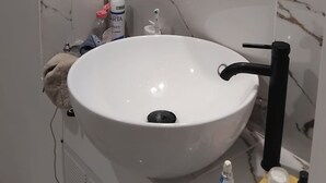 A bathroom with a white sink, a mirror, and a shower. - Apartment in the village of Tomino, 10 minutes from the sea and Macingaggio. (Tomino)