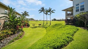 A well-maintained lawn with palm trees and a clear sky. - Pili Mai at Poipu - Condo on Kiahuna Golf Course - Pool, Spa, AC, Walk to Beach (Koloa)