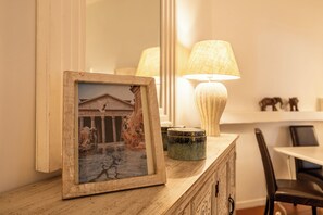 A framed picture on a wooden dresser, a lamp, and a small decorative item. - Campo dei Fiori Silver Apartment (Roma)