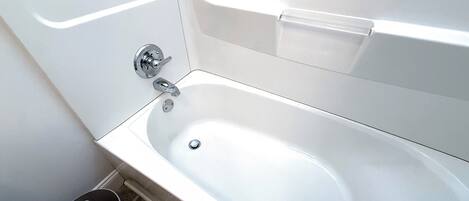 A white bathtub with a chrome faucet and a single lever handle.