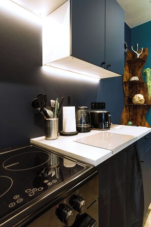 A kitchen with a stove, coffee maker, and utensils on the counter. - Les Grèves, Village Center, 80 meters from the beach (Saint-Jacut-de-la-Mer)
