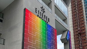 A building with a large, colorful sign that reads 'ELEVEN CLUB' and a modern architectural design. - E2611 - West-View Studio with Balcony in Downtown Miami (Miami)