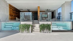 A modern building with a swimming pool, glass-enclosed areas, and a staircase leading to an upper level. - E2611 - West-View Studio with Balcony in Downtown Miami (Miami)