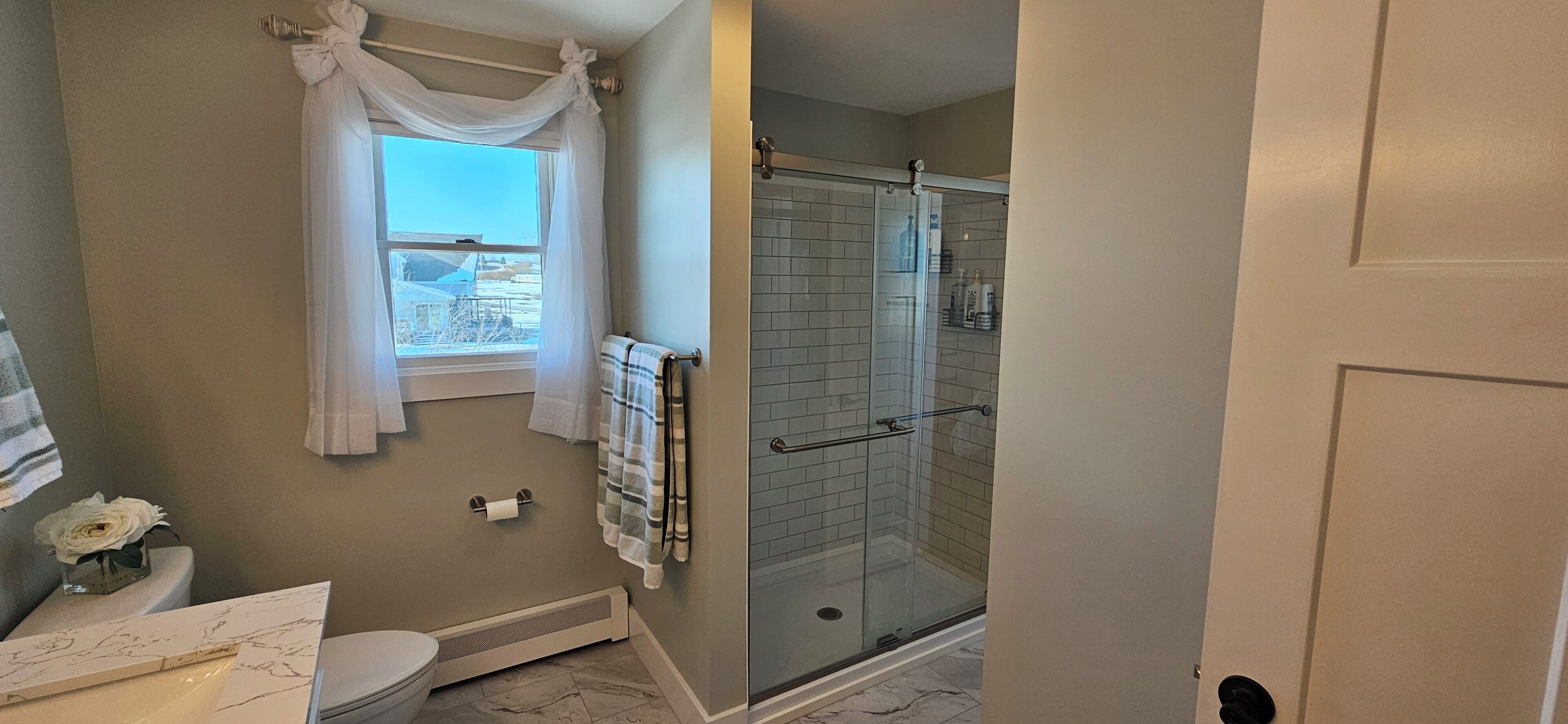 Shower, hair dryer, towels, toilet paper