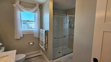 Shower, hair dryer, towels, toilet paper
