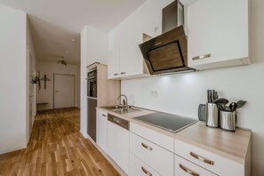 Una cocina moderna con lavavajillas, horno y pileta de acero inoxidable.