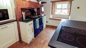 A kitchen with a stove, oven, and microwave. - Claybottom Farm (Wigton)