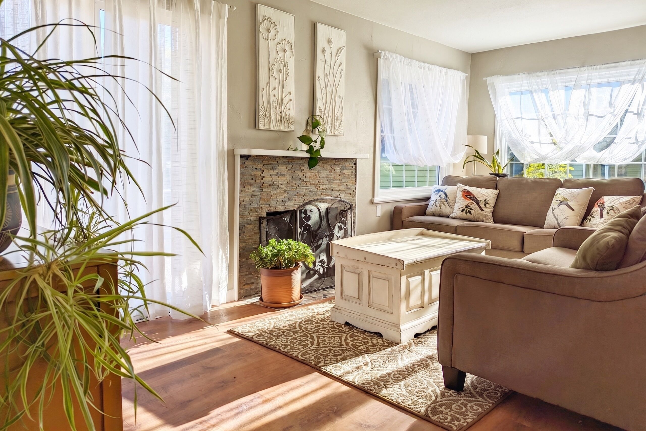 A cozy living room with a fireplace, a sofa set, and a coffee table.