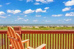 A wooden deck with a view of a beach and ocean. - Crystal Beach Serenity Escape: 4BR Beachfront! Stunning Views & Outdoor Showers (Bolivar Peninsula)