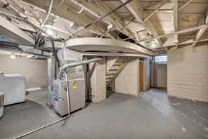 Ein Funktionsraum mit freiliegenden Deckenbalken, Lüftungsrohren und einer großen Industrieanlage.