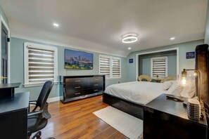 Ein modernes Schlafzimmer mit Bett, Schreibtisch und Stuhl.