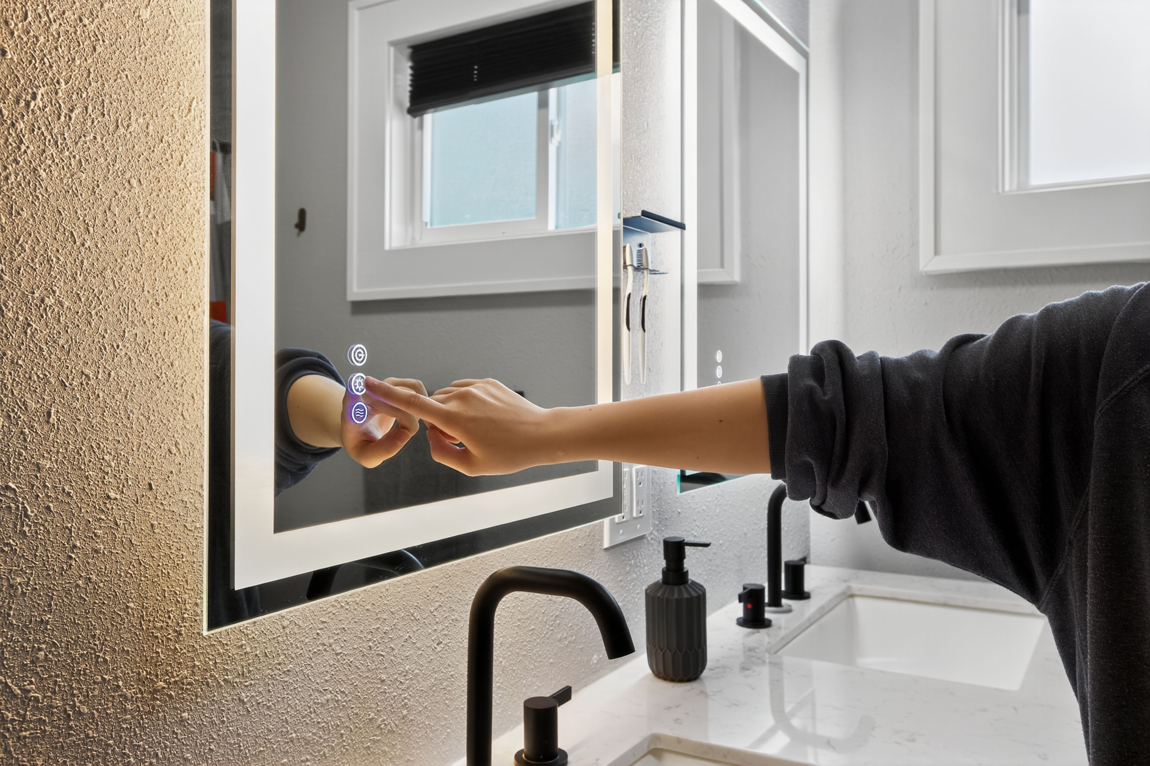 A bathroom with a large mirror, a sink, and a faucet.