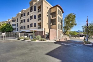 A multi-story hotel with a modern architectural design, featuring balconies and a gated entrance. - 2-bedroom condo with Pool, Sauna, Fitness Center and Game room.  (Phoenix)