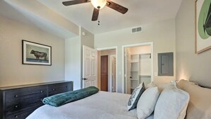 A bedroom with a bed, a dresser, a ceiling fan, and a door leading to a closet. - 2-bedroom condo with Pool, Sauna, Fitness Center and Game room.  (Phoenix)