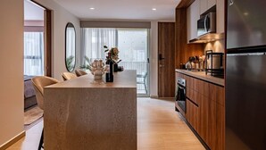 A modern kitchen with a central island, wooden cabinetry, and stainless steel appliances. - 3 Private Apts in Condesa with Private Terrace (Mexico City)