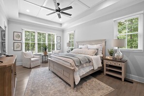 A bedroom with a bed, a chair, a nightstand, a desk, and a ceiling fan. - McLemore Resort - 18 Hawthorne Lane - Golf Course View (Rising Fawn)