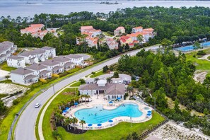 A residential area with houses, a swimming pool, and a road. - New Listing! Lost Key Golf & Beach Club| 3 king beds| Free Golf Daily| Two Pools| Tennis| Pickleball (Pensacola)