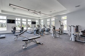 A modern gym with cardio machines, weight stations, and large windows. - New Listing! Lost Key Golf & Beach Club| 3 king beds| Free Golf Daily| Two Pools| Tennis| Pickleball (Pensacola)