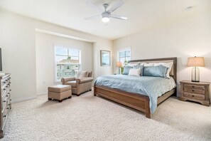 A bedroom with a bed, a chair, a dresser, a nightstand, and a ceiling fan. - New Listing! Lost Key Golf & Beach Club| 3 king beds| Free Golf Daily| Two Pools| Tennis| Pickleball (Pensacola)