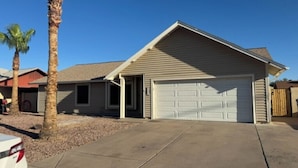 A single-story house with a garage, palm trees, and a clear sky. - Private Mesa Guest Suite |Shared Pool, Patio & BBQ (Mesa)