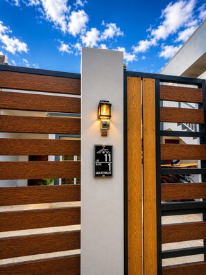 A gated entrance with a sign indicating 'LOT BLOCK 1' and 'CASA DE PADILLOS'.