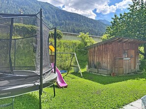 A trampoline with a slide, a wooden shed, and a mountain backdrop. - Ferienhaus Gundi by Interhome (Pettneu am Arlberg)
