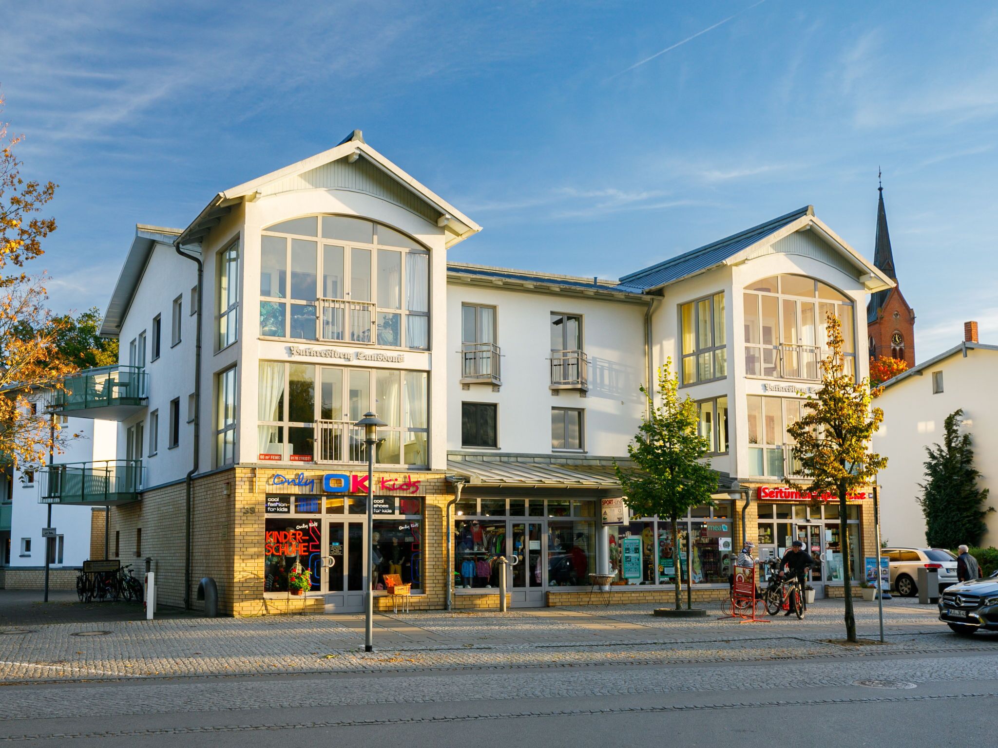 A multi-story building with large windows and a corner entrance.