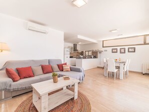 A modern living room with a sofa, coffee table, and dining area with chairs. - Garlanda by Interhome (Llombards/C.Llombards/C.S'Almonia)