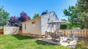 A single-story house with a patio area featuring a table and chairs, a covered grill, and a wooden fence. - Work, Play & Explore w/ Ease! Dtwn Meridian Apt (Meridian)