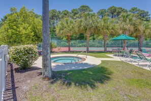 A swimming pool with a surrounding deck, lounge chairs, and a tennis court. - Golf Resort Stay in Sunset Beach: Pool, Balcony (Sunset Beach)