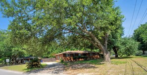 A residential area with a house, a speed limit sign, and a large tree. - Aiken Equestrian Dog Friendly  Bruce's Field (Aiken)