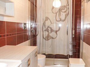 A bathroom with a shower, toilet, and vanity. - Casa Mandarino by Interhome (Bordighera)