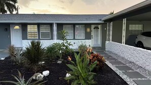 A residential house with a garage, a driveway with stepping stones, and various plants. - Viceroy 3 bedrooms (Cape Coral)