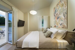 A bedroom with a bed, a TV on the wall, and a large window. - Villa Pepo (Istria - Pićan) (Pićan)