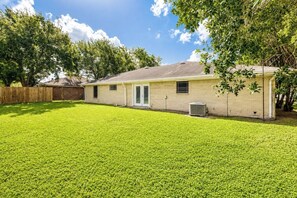 A single-story house with a well-maintained lawn, a front door, and a side window.
