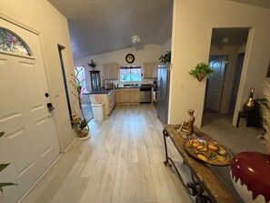 A kitchen with a central island, wooden cabinets, and a refrigerator. - 2-bedroom Ivory Wellness Retreat Prescott Lakes (Prescott)