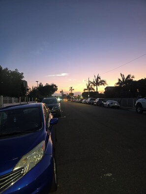 A street view at dusk with parked cars and a clear sky. - Tranquil studio with AC in charming Hawthorne perfect for getaway (Hawthorne)