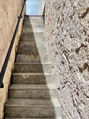 A set of stone steps leading upwards, flanked by rough-textured walls. - Black House - Modern 3BR Villa with Private Pool (Tulum)
