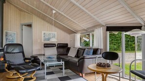 A modern living room with a glass coffee table, leather sofas, and a wooden floor. - "Ljubinko" - 300m from the sea by Interhome (Sydals)