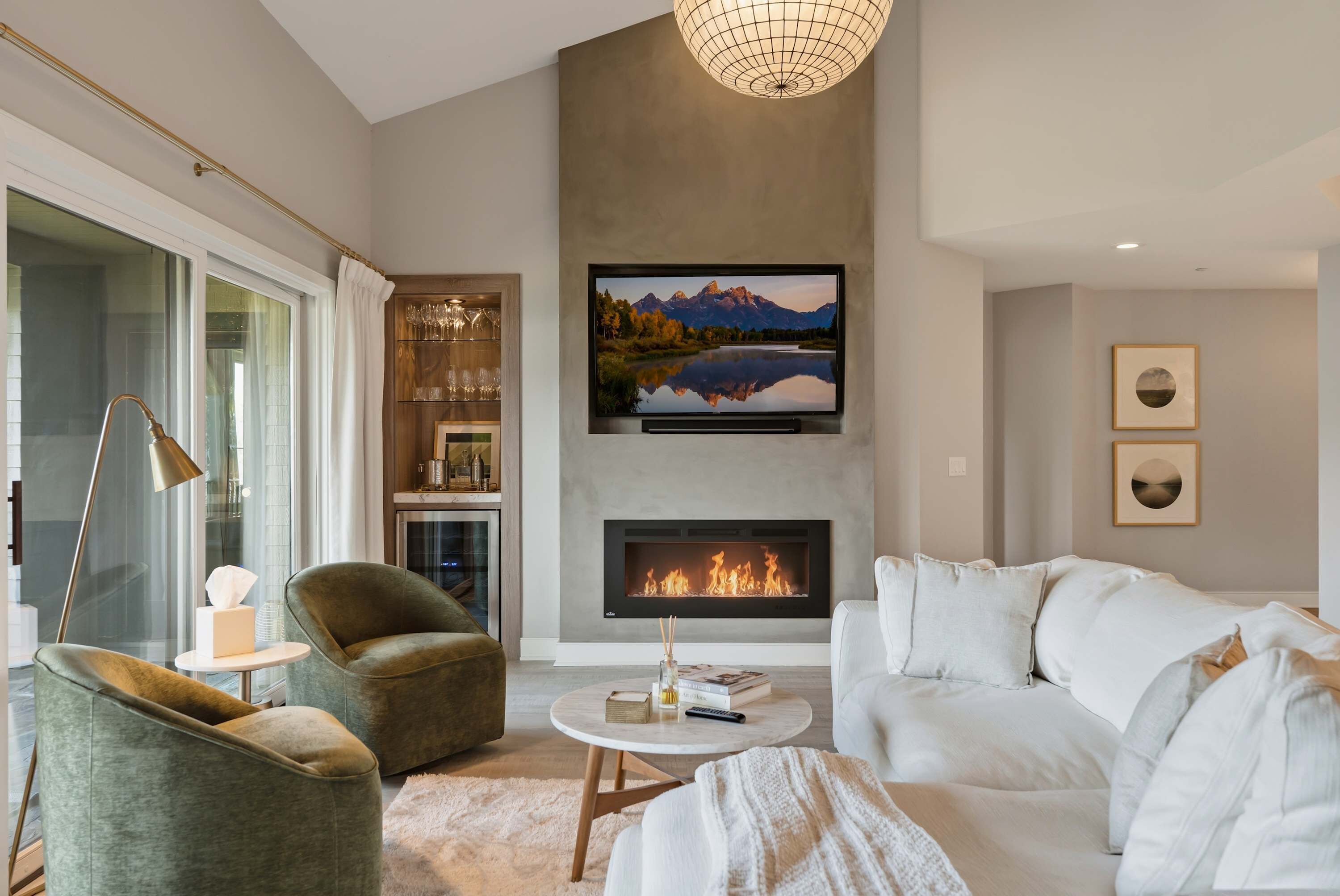 Fireplace, big-screen TV and a built-in bar with glassware