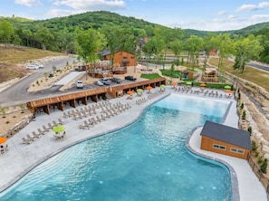 A resort with a large pool, outdoor seating, and a view of the surrounding hills. - 8 Tall Oaks - Tall Timbers Escape (Hollister)
