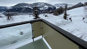 A snowy mountain landscape with a view from a balcony. - Ferienwohnungen JHS, (Seewis), by Interhome (Seewis im Prättigau)