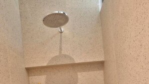 A shower enclosure with a handheld showerhead and a wall-mounted faucet. - Casa Cemagi - Luxury 3BR Villa Near Beach by Orivista (Kecamatan Mengwi)