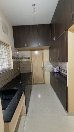Family Apartment, Balcony, City View | Private kitchen | Oven, cookware/dishes/utensils - Govinda Nivas Homestay (Tirupati)