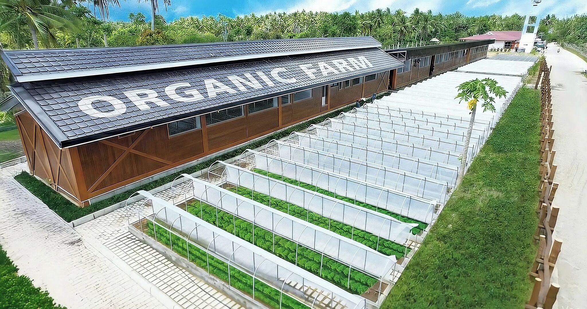 An organic farm with a large building and multiple greenhouses.