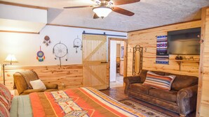A cozy room with a bed, a sofa, a ceiling fan, a TV, and a wall with dreamcatchers. - Dream Catcher

Dream Catcher (Red River)