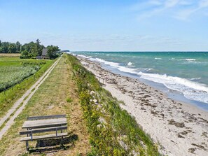 A coastal path with a bench and a view of the ocean.