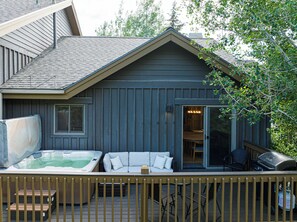 A house with a hot tub, a covered deck, and a barbecue grill. - 5BR Park City retreat with hot tub, fireplace, mountain views. (Park City)